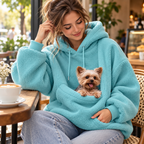 Vetsuno Cozy Carrier Hoodie in blue with a small dog in the front pouch at a cafe